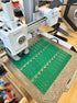 a 3d printer with green whistles on the print bed