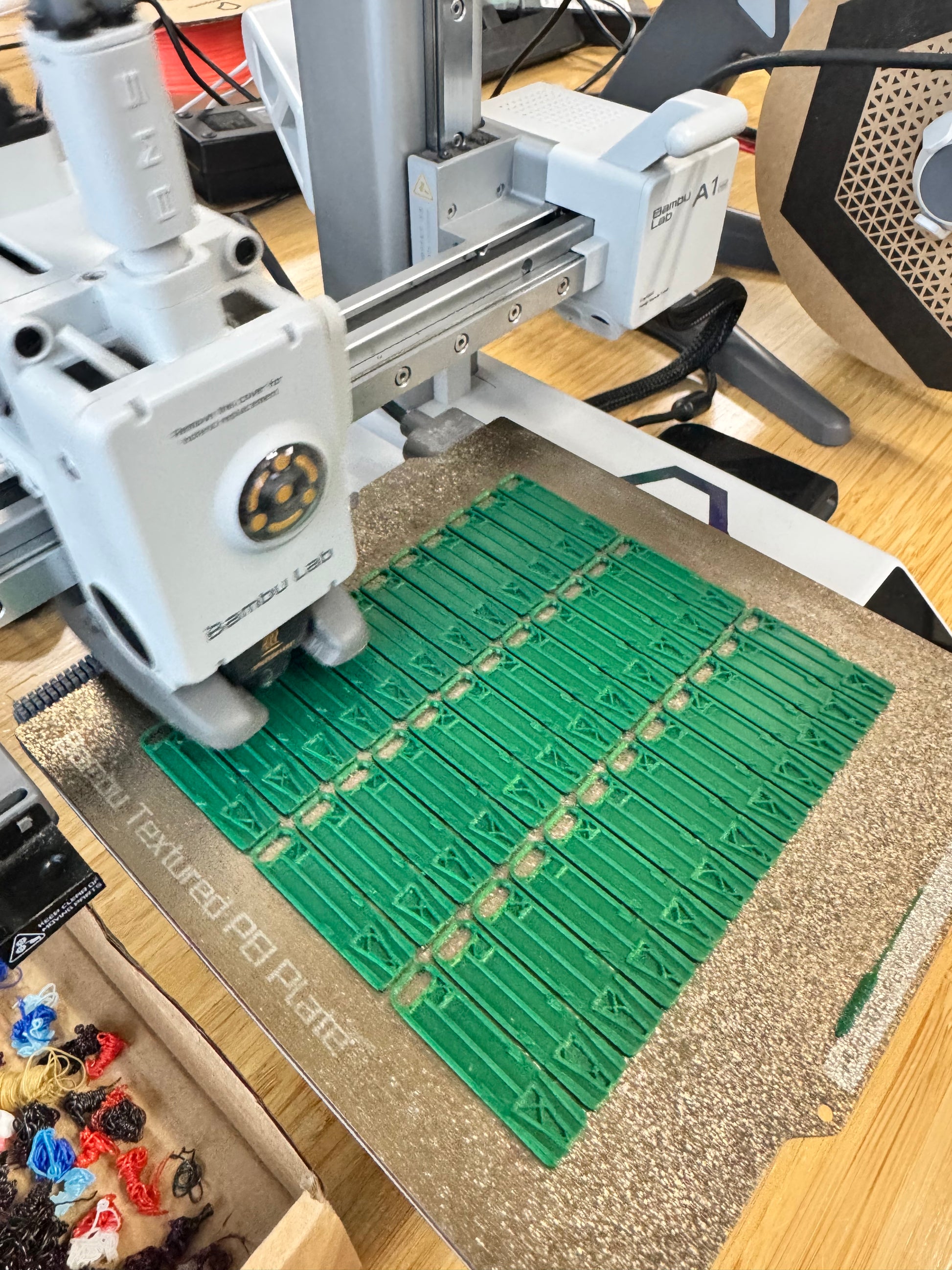 a 3d printer with green whistles on the print bed